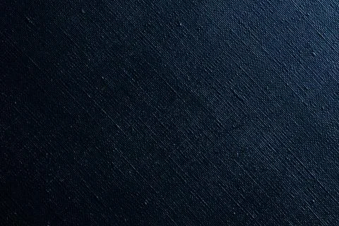 Dark creative background: black primed linen canvas, uneven lighting, color t Stock Photos