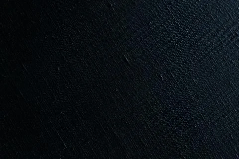 Dark creative background: black primed linen canvas, uneven lighting, color t Stock Photos