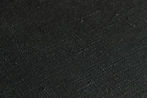 Dark creative background: black primed linen canvas, uneven lighting, toning Stock Photos