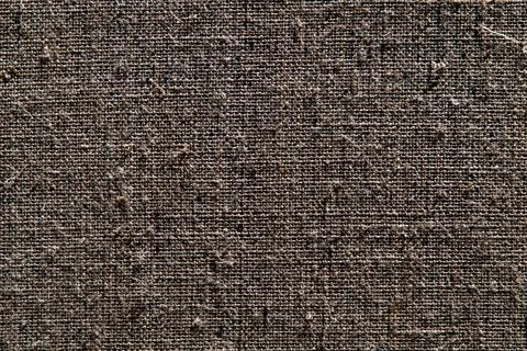 Dark creative background: reverse side of black-primed linen canvas, uneven l Stock Photos