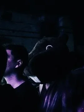 Dark crowd in purple light at night event Stock Photos