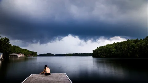 Dark cumulus storm clouds approaching a cottage dock on Lake Joseph, Ontario. Stock Footage 95311720