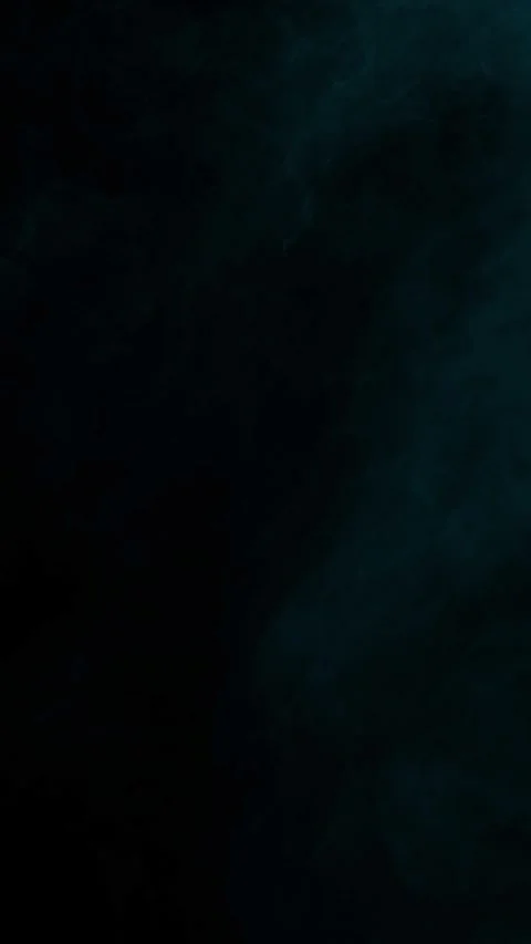 Dark cyan fog creating a cold atmosphere on black background, vertical format Stock Footage 340144971