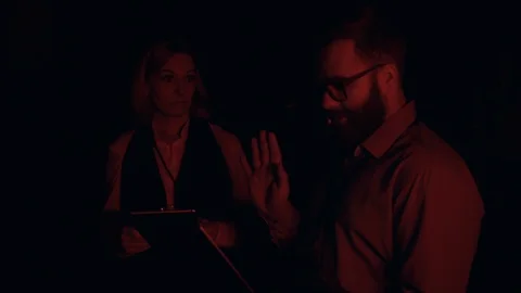 In dark data center stressful IT specialist trying to solve server error Stock Footage 120794427