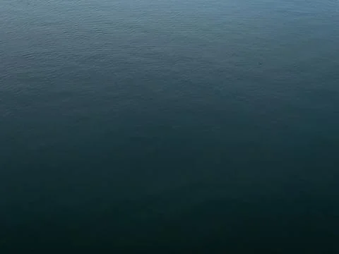Dark deep blue Waves ripple claming Lake background Stock Photos