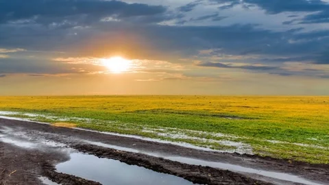 Dark dense clouds above a dirty spring fields Stock Footage 297759491