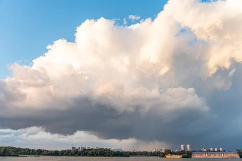 Dark, dense clouds filling upper half of image distant urban landscape sugg.. 写真素材