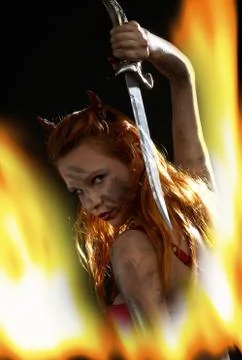 Dark devil girl with a knife in fire 스톡 일러스트