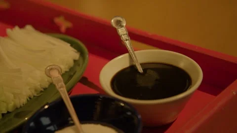 Dark Dipping Sauce and Sliced Vegetables Served on Tray in Beijing Restaurant Stock Footage 345773921