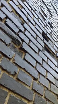 Dark dirty bricks. Old dark brick wall. Vintage background Stock Photos