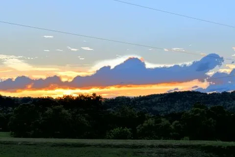 Dark distant farm sunset Stock Photos