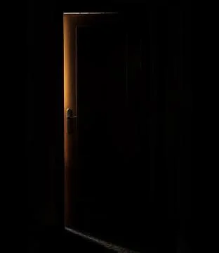 Dark door with glow behind Stock Photos