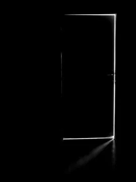 A dark door with a light behind it, light in the dark through an open door Stock Photos