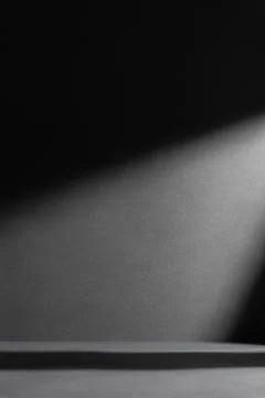 Dark dramatic background with sharp shadows and a beam of light. Minimalist a Stock Photos