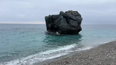 Dark Dramatic Coastal Rock Above Clear Aegean Water Stock Footage 322689350