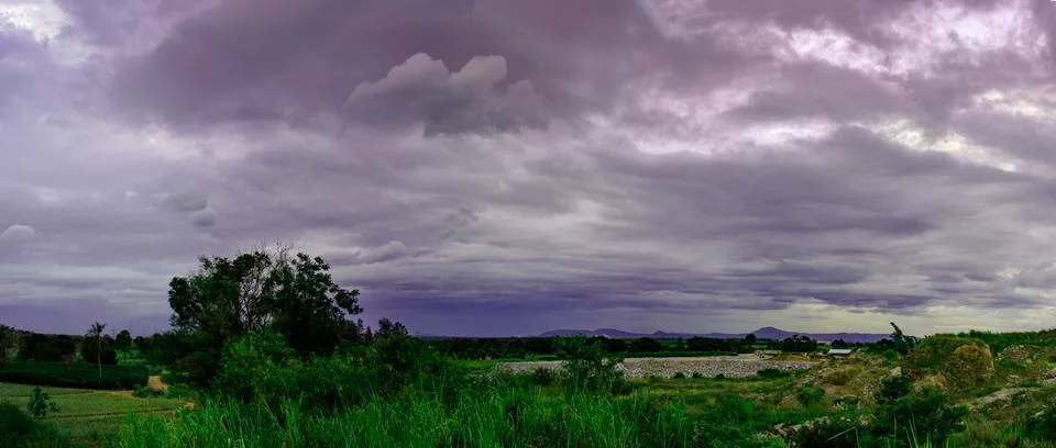 Dark dramatic landscape of sky clouds Stock Photos