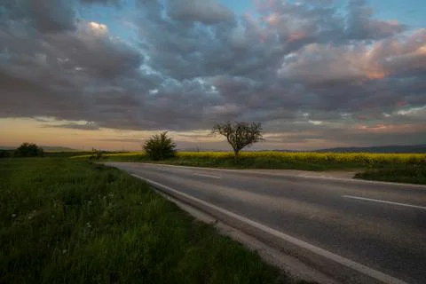 Dark dramatic landscape stormy sky over field Stock Photos