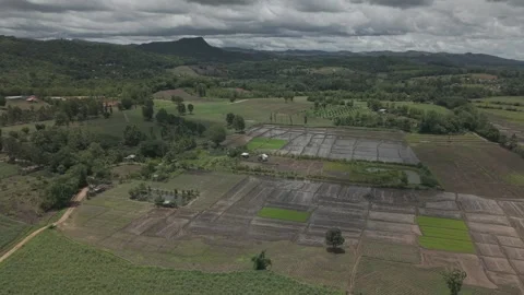Dark Dramatic Monsoon Clouds Over Mountain Silhouette and Green Valley Farm.. Stock-Footage 337014441