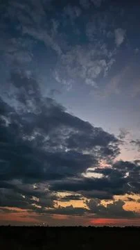Dark dramatic sky with clouds and sunset colors Stock Photos