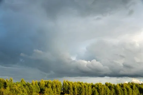Dark Dramatic Storm Clouds Gathering Over Forest Horizon Stock Photos