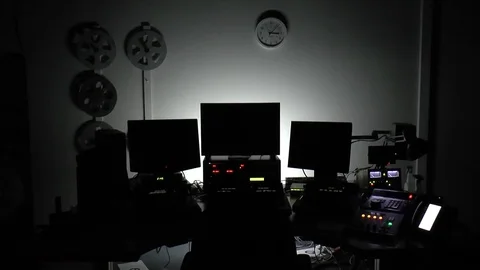 Dark edit suite with backlit screens Video stock 75958963