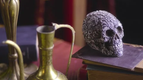 Dark Elegance: Renaissance-Inspired Setting with Skull, Books, and a Stock Footage 252582800