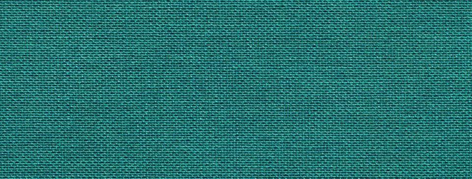 Dark emerald background from a textile material with wicker pattern, closeup. Stock Photos