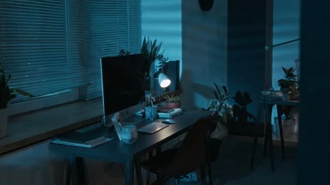 Dark Empty Office Showing Work Table with Computer Monitor and Lighted Lamp 스톡 동영상 321674258