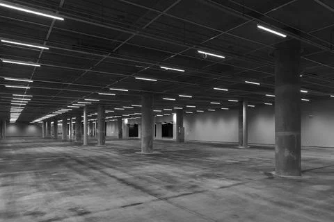Dark empty parking, concrete  interior with pillars and neon lights, modern.. Stock Photos