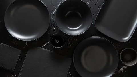 Dark empty plates without food on dark stone background, flat lay, top view. Stock Photos