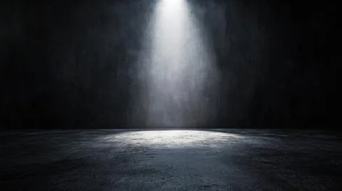 Dark empty room with spotlight illuminating a textured concrete floor against a Stock Photos