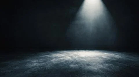 Dark empty room with spotlight illuminating a textured concrete floor against a Stock Photos