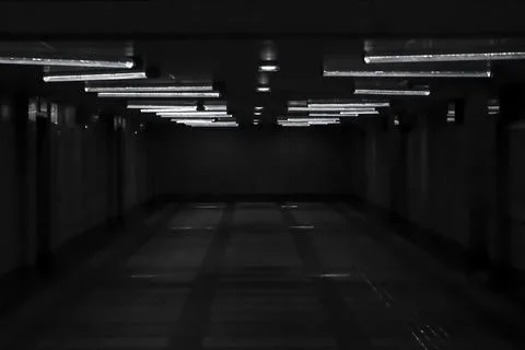 Dark empty underground corridor with lights Stock Photos