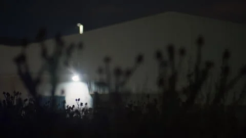 Dark empty warehouse exterior at night with eerie atmosphere Stock Footage 337792043