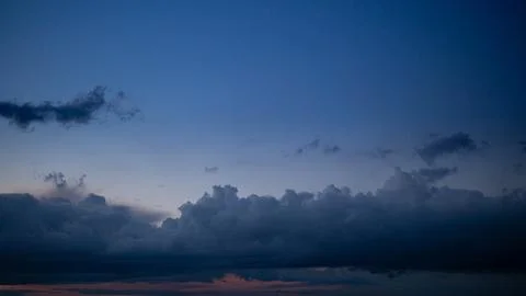 Dark evening sky with heavy clouds above the horizon. Stock Photos