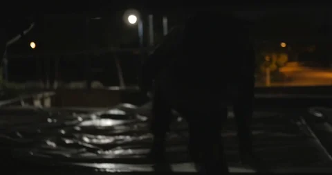 Dark Figures Break into Construction Site Stock Footage 87722193