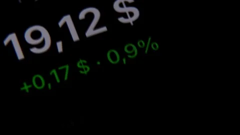 Dark financial display with white dollar digits and green market figures Stock Footage 345434953