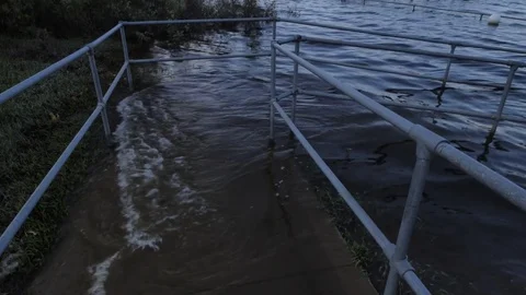 Dark Flooded Walkway with Waves at Sunset Stock Footage 82160427