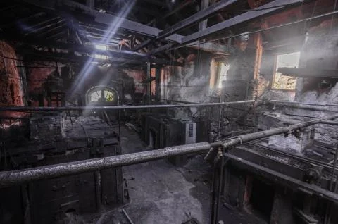Dark foundry with sunlight from outside Foto stock