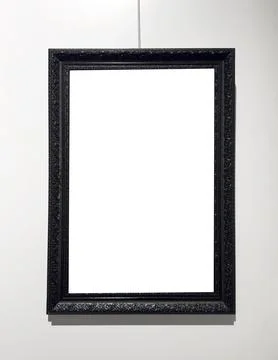 Dark frame hangs on string with empty interior space. Suspended border enclos Stock Photos
