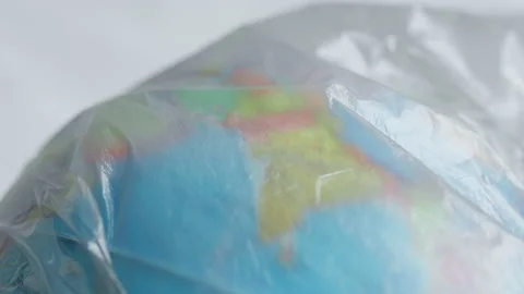 A dark garbage bag or polyethylene covers India and ocean on a globe Stock Footage 170141685