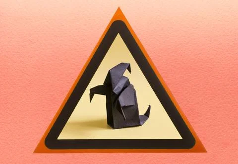 A dark ghost in close-up in a yellow triangle. Stock Photos