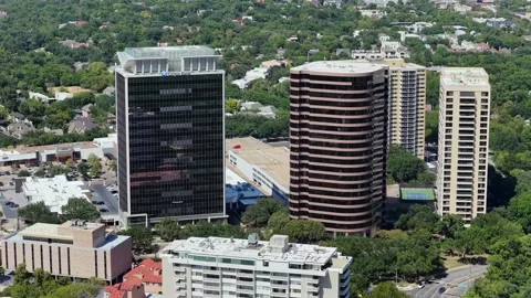 Dark Glass Tower and Brick Cylinders along Dallas Turtle Creek Stock Footage 343067380