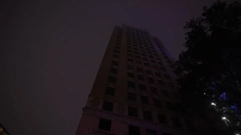 A dark gloomy motion looking up at a building in the foggy night. Stock Footage 301304623