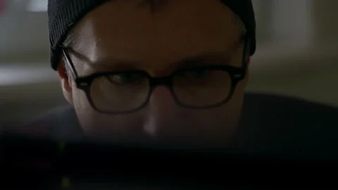 Dark gloomy portrait of a man hacking a computer Stock Footage 167169757