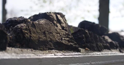 Dark Glossy Chunks On A Ledge, Outdoor Raw Material Detail, Close Up Shot Vídeo Stock 340641402