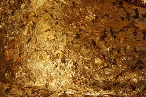The dark gold leaf foil texture background. Stock Photos