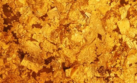 The dark gold leaf foil texture background. Stock Photos