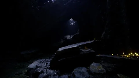 Dark Gothic Chamber. Eerie burial chamber illuminated by flickering candles Stock Footage 342439133