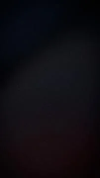 Dark gradient black navy blue and deep red vertical background with grainy .. 스톡 사진